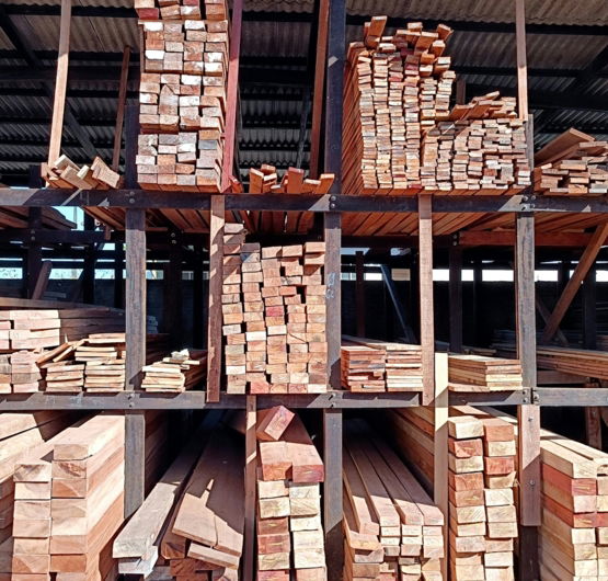 a-pile-of-wood-sitting-inside-of-a-building.jpg a pile of wood sitting inside of a building