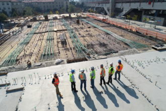 seven-construction-workers-standing-on-white-field.jpg seven construction workers standing on white field