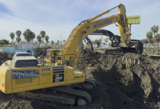 a-large-yellow-excavator-sitting-on-top-of-a-pile-of-dirt.jpg A large yellow excavator sitting on top of a pile of dirt